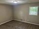Comfortable bedroom with neutral walls, new carpet and natural light at 6956 Kimberland Gardens Ln, Lithonia, GA 30058