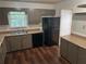 Functional kitchen with sleek black refrigerator and dishwasher at 6956 Kimberland Gardens Ln, Lithonia, GA 30058