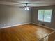 Spacious living room featuring hardwood floors and ample natural light at 6956 Kimberland Gardens Ln, Lithonia, GA 30058
