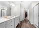 Bright bathroom showcasing a glass-enclosed shower, double vanity, and wood-look flooring at 1025 Cherryfield Run, Marietta, GA 30008