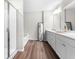 Bright bathroom showcasing a glass-enclosed shower, soaking tub, and double vanity with modern fixtures at 1025 Cherryfield Run, Marietta, GA 30008