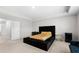 Spacious main bedroom featuring tray ceilings, a large bed with tufted headboard, and neutral decor at 1025 Cherryfield Run, Marietta, GA 30008