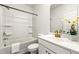 Bathroom featuring shower over tub, vanity, and flower accent at 1172 Edwin Ln, Sugar Hill, GA 30518