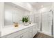 Bright bathroom featuring a double sink vanity, large mirror and stand up shower at 1172 Edwin Ln, Sugar Hill, GA 30518