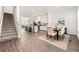 Open floor plan showcasing dining room with wood floors adjacent to a modern kitchen with stainless appliances at 1172 Edwin Ln, Sugar Hill, GA 30518