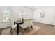 Bright dining room with wood-look flooring, neutral paint, and natural light from large windows at 1172 Edwin Ln, Sugar Hill, GA 30518