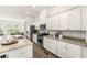 Kitchen with stainless dishwasher and a view of the kitchen island, countertops, and sink at 1172 Edwin Ln, Sugar Hill, GA 30518