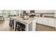 Kitchen island with granite countertop and seating area in an open floor plan, stainless appliances at 1172 Edwin Ln, Sugar Hill, GA 30518