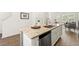 Kitchen features stainless steel appliances, granite countertops, and white cabinetry at 1172 Edwin Ln, Sugar Hill, GA 30518