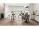 Bright living room features wood floors, a fireplace, and large windows for lots of natural light at 1172 Edwin Ln, Sugar Hill, GA 30518