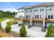 Rear exterior shows multiple homes with garages and back porches at 1172 Edwin Ln, Sugar Hill, GA 30518