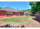 Grassy backyard with a well-maintained lawn, brick home exterior, and privacy fencing, ideal for outdoor activities at 2010 Hickory Station Cir, Snellville, GA 30078
