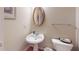 Bathroom features a sink, commode and decorative mirror at 2010 Hickory Station Cir, Snellville, GA 30078