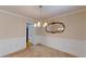 Elegant dining room featuring wainscoting, a chandelier, and a decorative mirror at 2010 Hickory Station Cir, Snellville, GA 30078