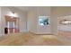 Spacious living room featuring neutral carpet and an open layout leading to other rooms at 2010 Hickory Station Cir, Snellville, GA 30078