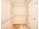 Spacious walk-in closet featuring white wire shelving and neutral carpeting, offering ample storage at 2010 Hickory Station Cir, Snellville, GA 30078