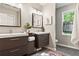 Elegant bathroom featuring double vanities, modern lighting, and a window offering natural light, creating a spa-like retreat at 2089 College Ne Ave, Atlanta, GA 30317