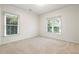 Bright, carpeted bedroom with two windows offering ample natural light, creating a serene and inviting atmosphere at 2089 College Ne Ave, Atlanta, GA 30317
