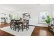 Bright dining room with hardwood floors, large windows, and view of the kitchen at 2089 College Ne Ave, Atlanta, GA 30317