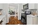 Modern kitchen featuring white cabinets, stainless steel appliances, and stylish backsplash at 2089 College Ne Ave, Atlanta, GA 30317