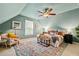 Stylish primary bedroom boasting vaulted ceilings, a ceiling fan and a comfortable seating area at 2089 College Ne Ave, Atlanta, GA 30317