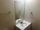 Modest bathroom with a white single sink vanity, a frameless mirror, and chrome fixtures at 3827 Micah Ln, Ellenwood, GA 30294