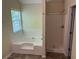 Bathroom featuring a separate shower and a luxurious soaking tub for relaxation at 3827 Micah Ln, Ellenwood, GA 30294