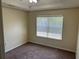 An empty bedroom features a large window letting in natural light, complemented by a trey ceiling at 3827 Micah Ln, Ellenwood, GA 30294