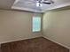 An empty bedroom features a large window letting in natural light, complemented by a trey ceiling at 3827 Micah Ln, Ellenwood, GA 30294