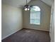 An empty bedroom featuring a large window letting in natural light, complemented by a ceiling fan at 3827 Micah Ln, Ellenwood, GA 30294