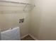A functional laundry room area with overhead shelving and easy access to water and power connections at 3827 Micah Ln, Ellenwood, GA 30294