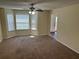 Inviting living room filled with light from bay windows and featuring a ceiling fan at 3827 Micah Ln, Ellenwood, GA 30294
