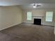 Spacious living room featuring a fireplace and large windows that invite plenty of natural light at 3827 Micah Ln, Ellenwood, GA 30294