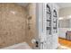Modern bathroom showcasing decorative tile in the shower, a large cabinet, and natural hardwood floors at 3231 Connemara Trce, Lawrenceville, GA 30044