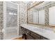 Bathroom featuring decorative wallpaper, a large mirror, and a white countertop sink vanity at 3231 Connemara Trce, Lawrenceville, GA 30044