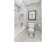 Bathroom with marble tile, floral wallpaper, a shower with glass surround and a toilet at 3231 Connemara Trce, Lawrenceville, GA 30044