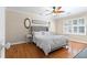 Comfortable bedroom featuring a neutral color scheme, hardwood floors, and a window with shutters at 3231 Connemara Trce, Lawrenceville, GA 30044