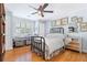 A comfortable bedroom with a ceiling fan, a window with shutters and hardwood flooring at 3231 Connemara Trce, Lawrenceville, GA 30044