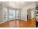 Bright dining area with hardwood floors and large, light-filled shuttered windows at 3231 Connemara Trce, Lawrenceville, GA 30044