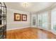 Bright dining area with hardwood floors, elegant lighting, and white shuttered windows at 3231 Connemara Trce, Lawrenceville, GA 30044
