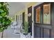Charming front porch with rocking chairs, decorative accents, and a stylish front door with leaded glass at 3231 Connemara Trce, Lawrenceville, GA 30044