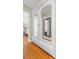 Hallway with hardwood floors and custom mirrored doors leading to the bedroom at 3231 Connemara Trce, Lawrenceville, GA 30044