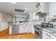 Gourmet kitchen featuring marble countertops, stainless steel appliances, and custom cabinetry at 3231 Connemara Trce, Lawrenceville, GA 30044