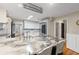 Open kitchen with marble countertops, a central island with seating, and stainless appliances at 3231 Connemara Trce, Lawrenceville, GA 30044