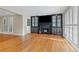 Bright living room featuring hardwood floors, a fireplace with built-ins, and plantation shutters at 3231 Connemara Trce, Lawrenceville, GA 30044