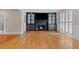 Cozy living room with hardwood floors, a fireplace with built-in cabinets, and plantation shutters at 3231 Connemara Trce, Lawrenceville, GA 30044