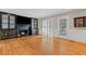 Open living room with hardwood floors, a fireplace with built-in cabinetry, and lots of natural light at 3231 Connemara Trce, Lawrenceville, GA 30044