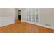 Bright living room with hardwood floors, white plantation shutters, and elegant trim at 3231 Connemara Trce, Lawrenceville, GA 30044