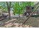Backyard featuring a playground, mature trees, and a patio with dining and lounge seating for Gathering entertainment at 3231 Connemara Trce, Lawrenceville, GA 30044