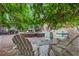 Relaxing poolside brick patio area with outdoor seating, mature trees, and manicured landscaping for outdoor enjoyment at 3231 Connemara Trce, Lawrenceville, GA 30044
